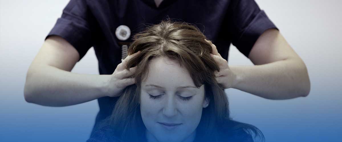 Kerryanne performs an Indian Head Massage on a patient at Real-Ease in Newcastle-under-Lyme